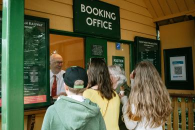Visitors buying their ticket at the booking office