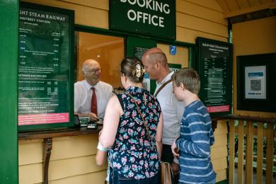 Visitors buying their ticket at the booking office